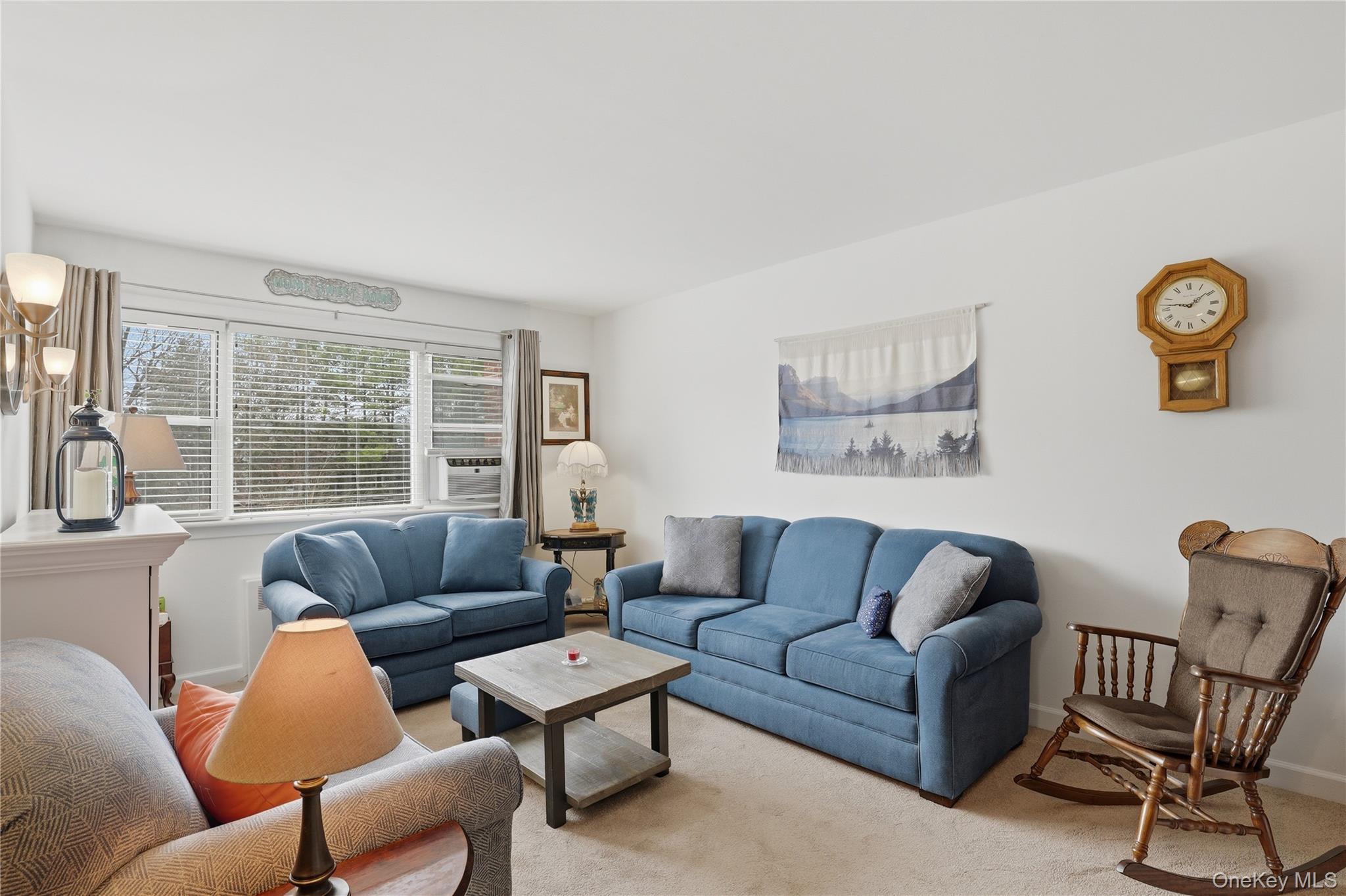352 North State Road, Unit 1H Briarcliff Manor, NY 10510 - Photo 4 of 20 a living room with furniture and a large window