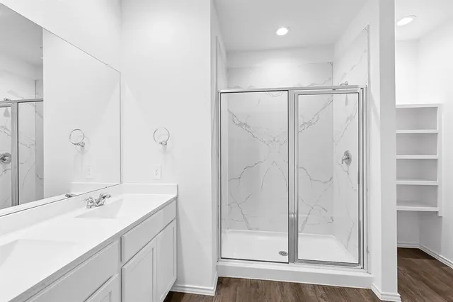 a bathroom with a double vanity sink and mirror