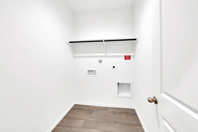 a kitchen with a sink and wooden floor