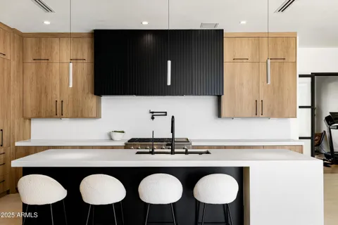 a living room with furniture a refrigerator and kitchen view