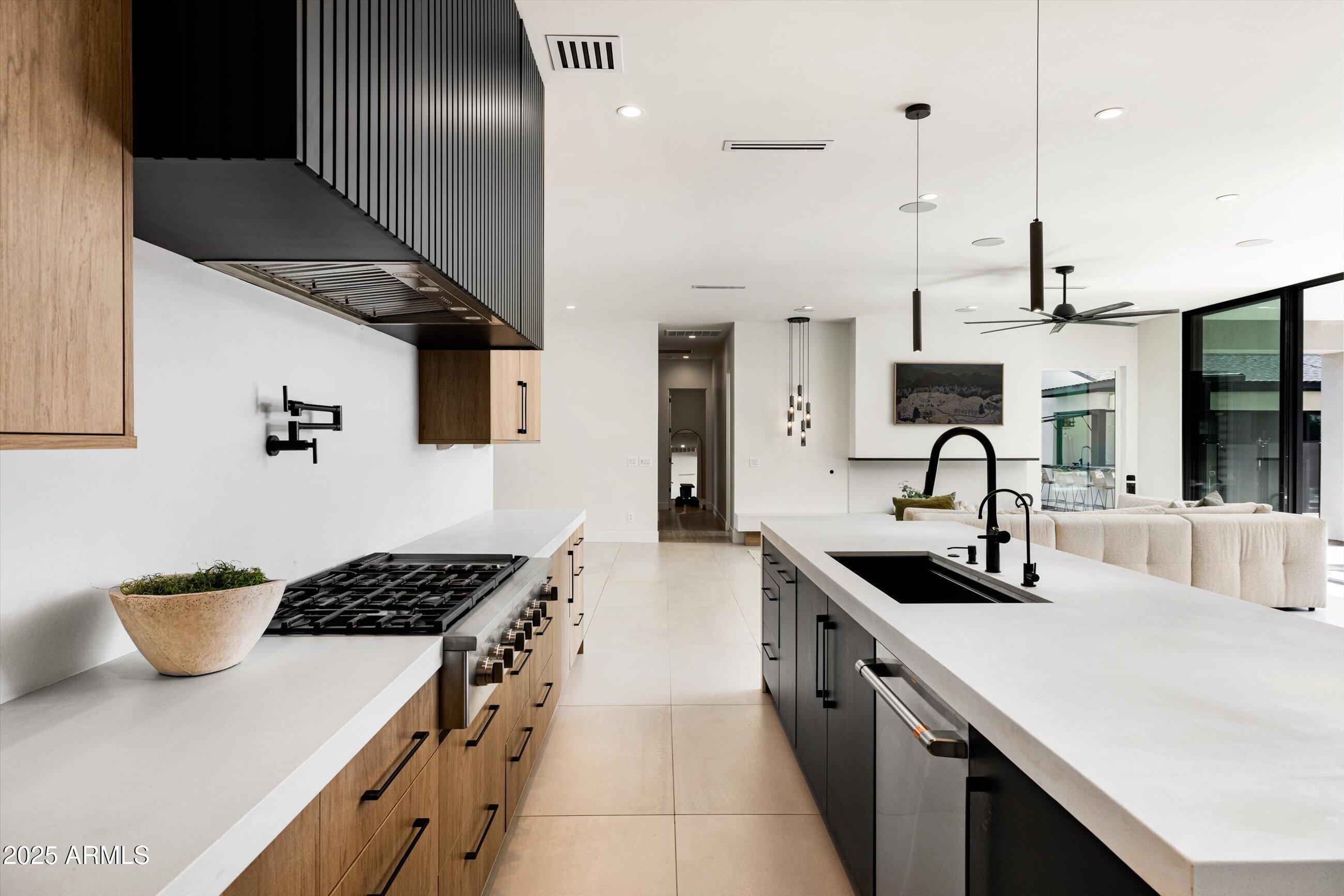 3721 East Piccadilly Road Phoenix, AZ 85018 - Photo 16 of 54 a kitchen with stainless steel appliances a sink a stove and a wooden floors
