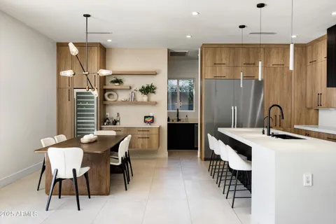 a kitchen with stainless steel appliances a sink a stove and a wooden floors