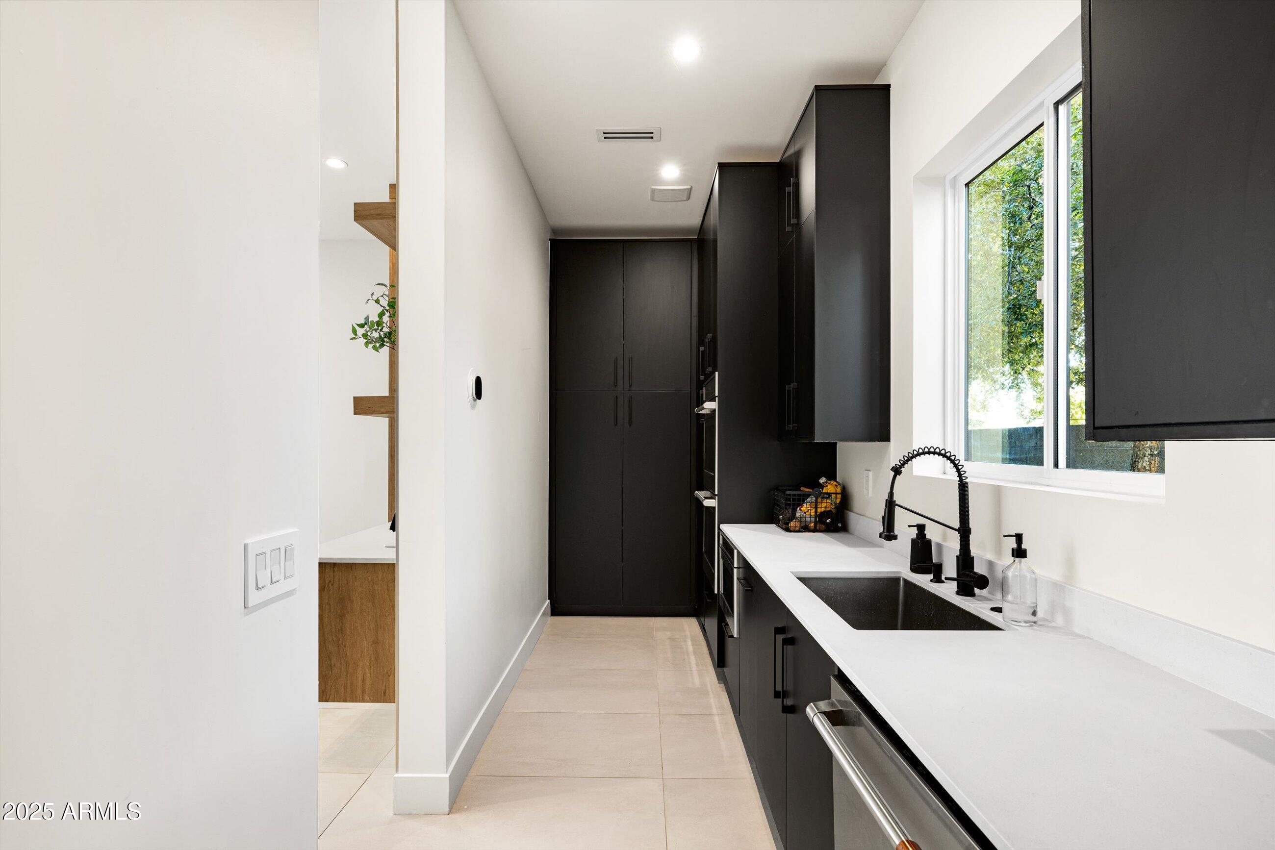 3721 East Piccadilly Road Phoenix, AZ 85018 - Photo 20 of 54 a kitchen with a sink and a refrigerator