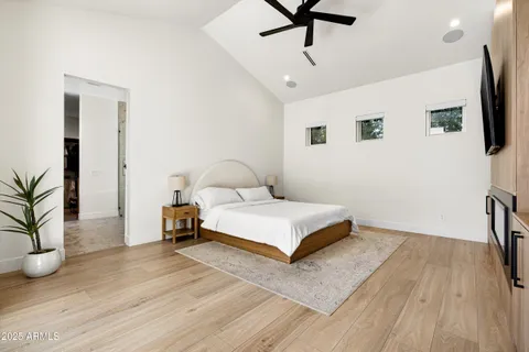 a view of a dining room with furniture a chandelier and large windows
