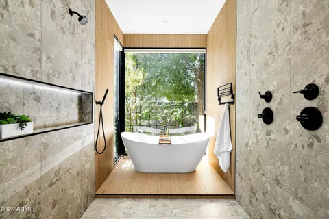 a bathroom with a double vanity sink a mirror and shower