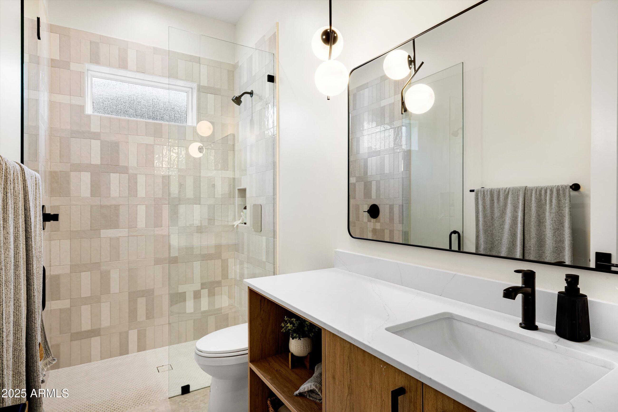 3721 East Piccadilly Road Phoenix, AZ 85018 - Photo 30 of 54 a bathroom with a sink a toilet and shower