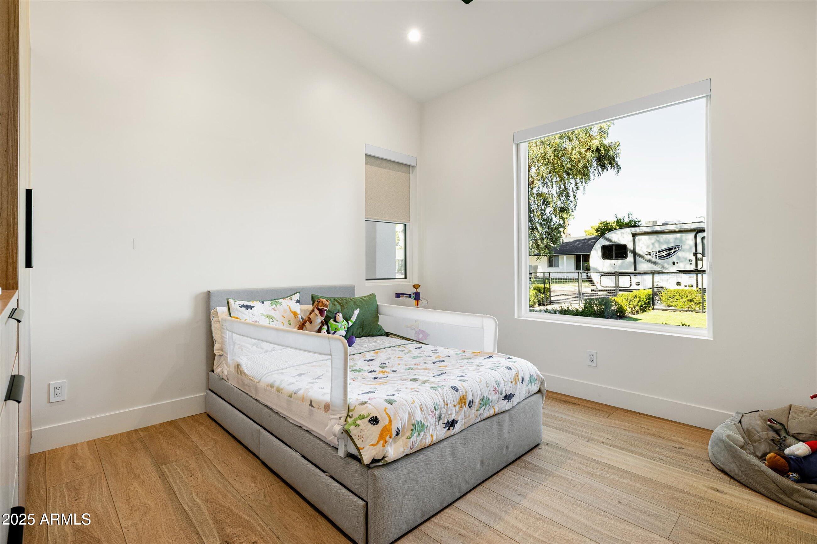 3721 East Piccadilly Road Phoenix, AZ 85018 - Photo 31 of 54 a bedroom with a bed table and window