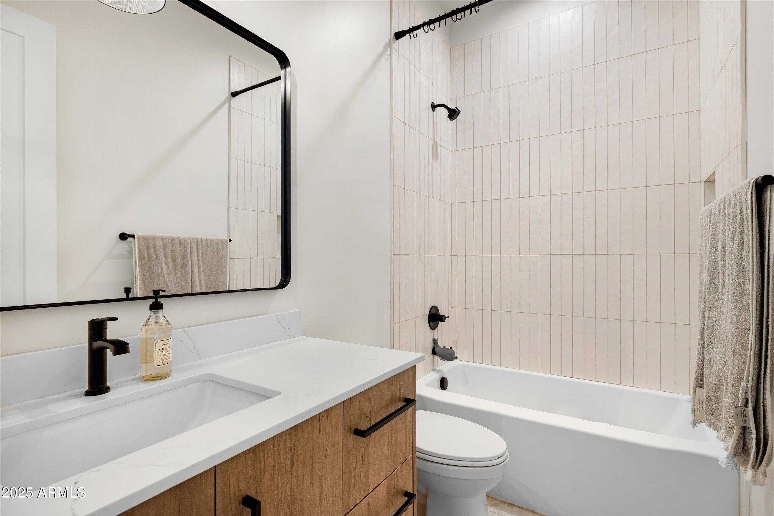 3721 East Piccadilly Road Phoenix, AZ 85018 - Photo 32 of 54 a bathroom with a granite countertop sink toilet and shower