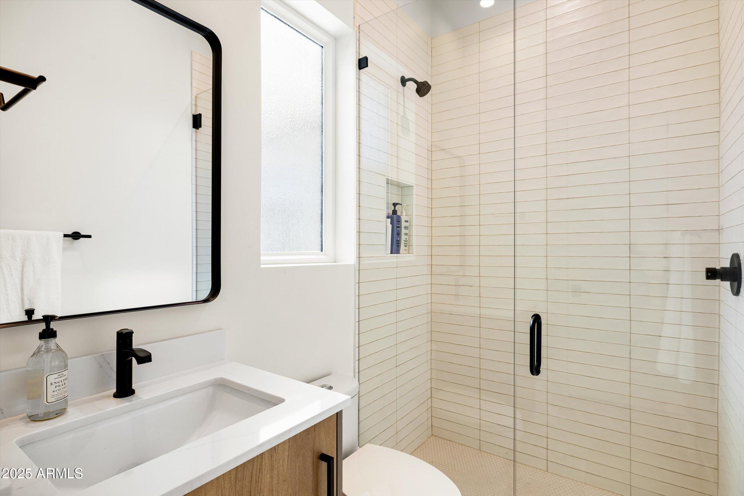 3721 East Piccadilly Road Phoenix, AZ 85018 - Photo 34 of 54 a bathroom with a sink toilet and shower