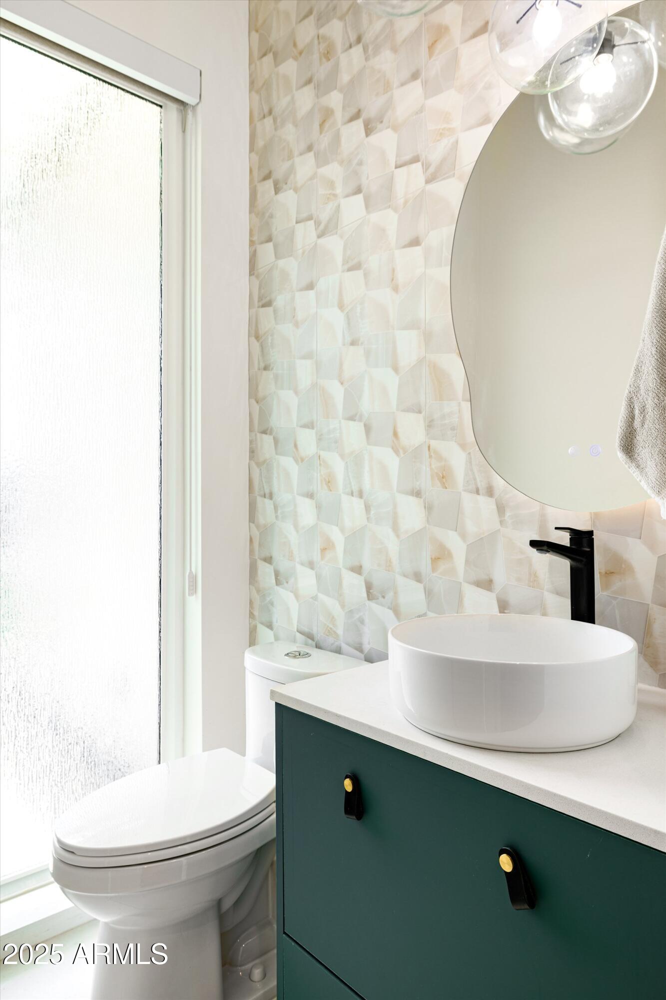 3721 East Piccadilly Road Phoenix, AZ 85018 - Photo 35 of 54 a bathroom with a sink a toilet and mirror