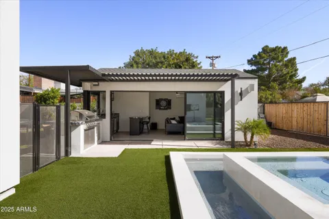 a view of a house with swimming pool and sitting area