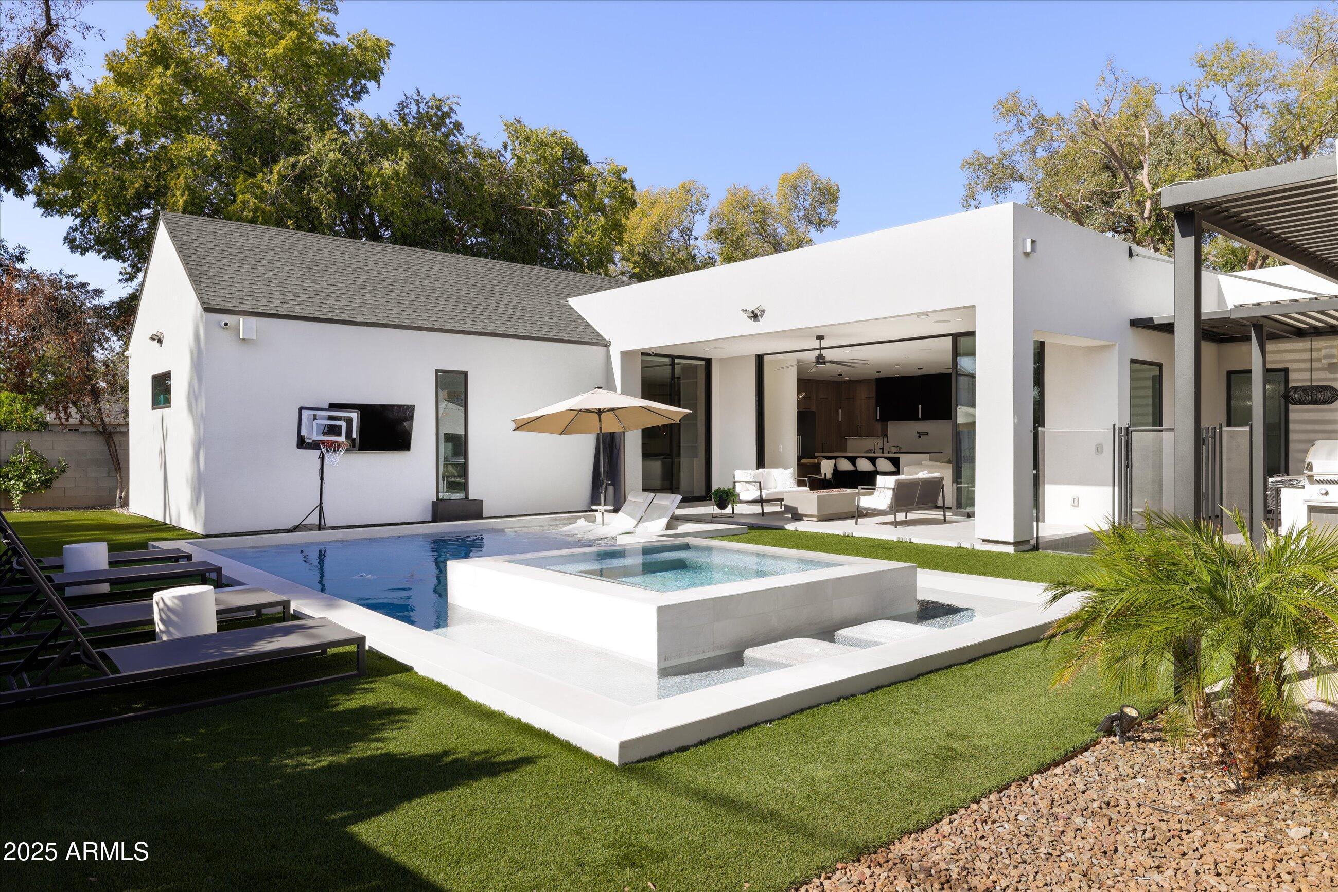 3721 East Piccadilly Road Phoenix, AZ 85018 - Photo 49 of 54 a view of a house with swimming pool and sitting area