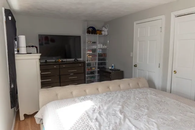 a bed sitting in a bedroom next to a window