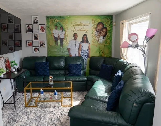 a living room with furniture and wall paintings