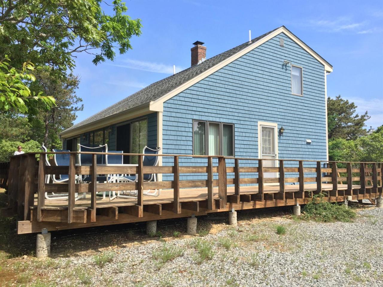 1 Schoolhouse Road Edgartown, MA 02539 - Photo 1 of 14 a view of a house with a yard chairs and iron fence