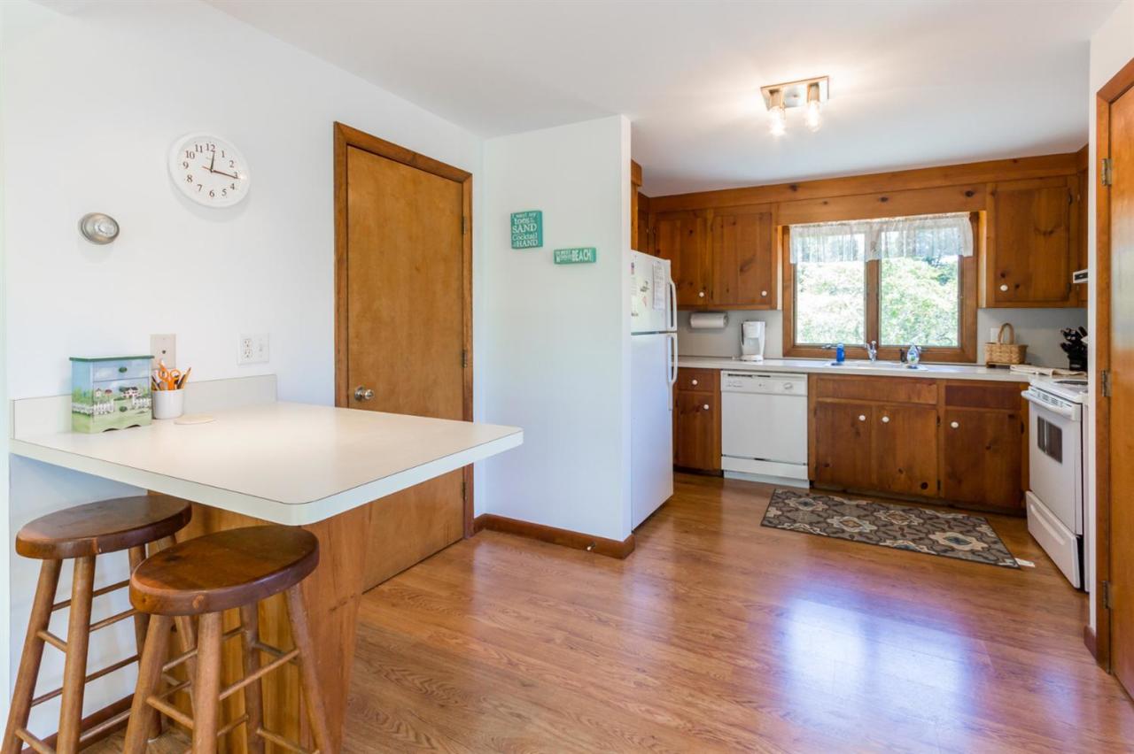 1 Schoolhouse Road Edgartown, MA 02539 - Photo 3 of 14 a kitchen with a wooden floor and a refrigerator