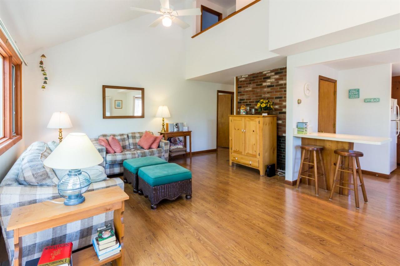 1 Schoolhouse Road Edgartown, MA 02539 - Photo 6 of 14 a bedroom with furniture and a wooden floor