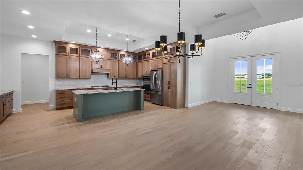 20130 Sugarloaf Mountain Road Clermont, FL 34715 - Photo 11 of 18 a kitchen with stainless steel appliances granite countertop a refrigerator and a sink