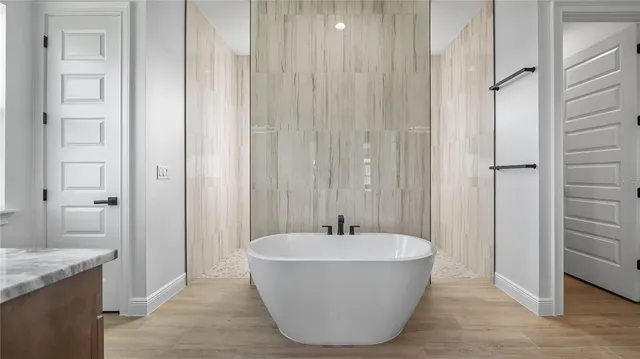 a bathroom with a bathtub and shower