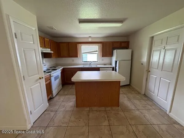 a large kitchen with cabinets and stainless steel appliances