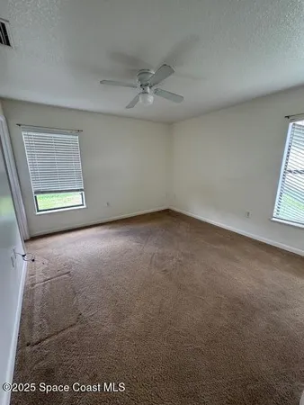 an empty room with windows and closet