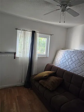 a bathroom with a sink a toilet a window and shower