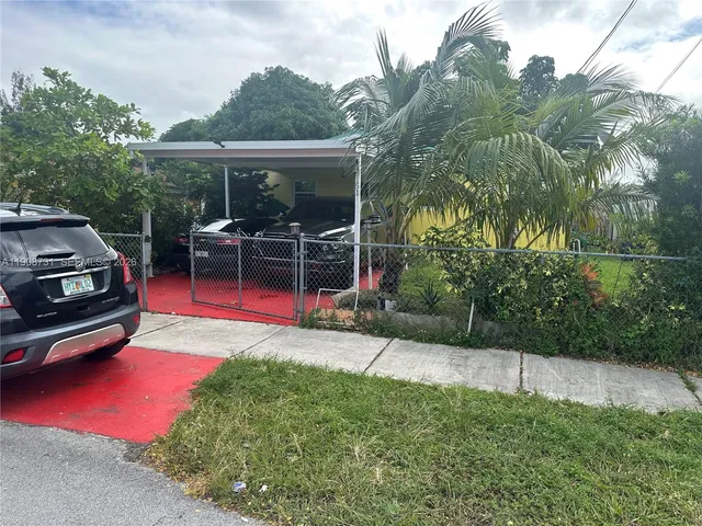 a view of a house with backyard porch and sitting area
