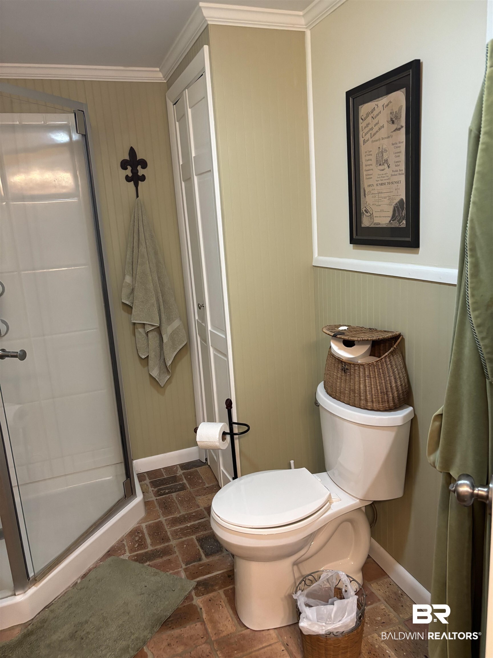 216 West Orange Avenue Foley, AL 36535 - Photo 11 of 37 Full bath with crown molding, a shower stall, toilet, baseboards, and brick floors