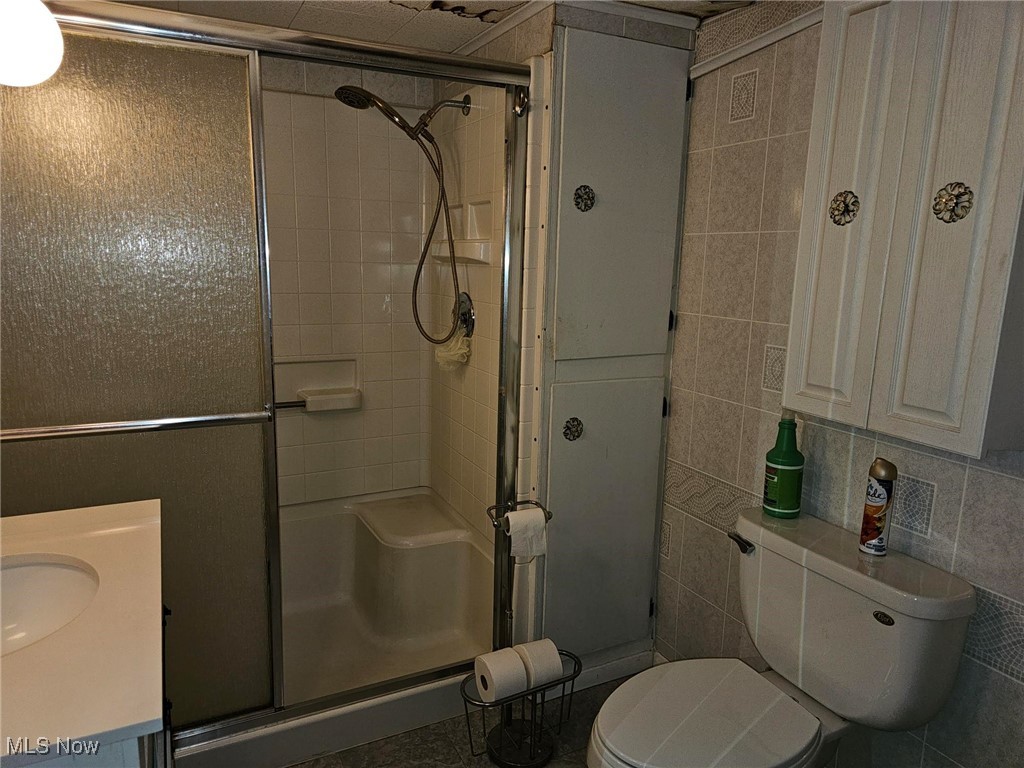 91510 Amos Road Scio, OH 43988 - Photo 11 of 12 Full bath with tile walls, a stall shower, and vanity