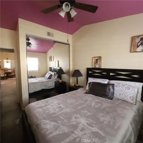 a bedroom with bed and a closet