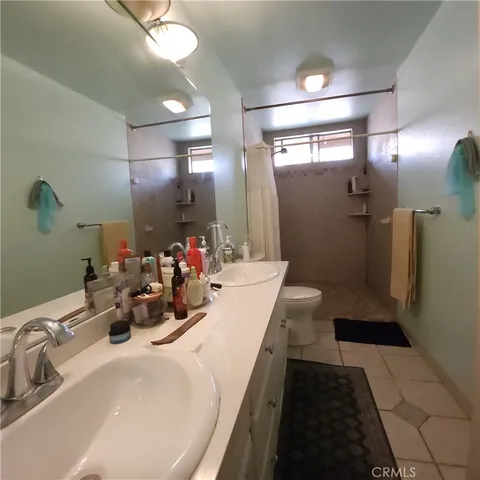 a bathroom with a sink a toilet and a mirror