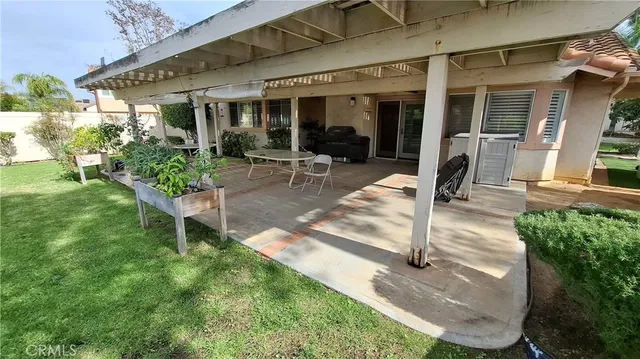 a view of a house with backyard porch and sitting area