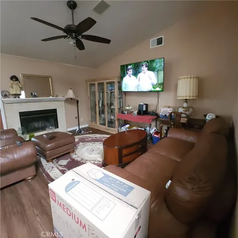 a living room with furniture a fireplace and a chandelier