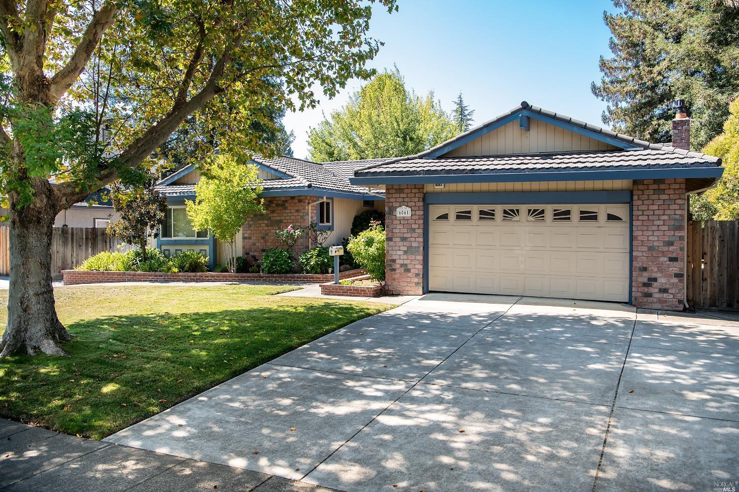 6061 Country Club Drive Rohnert Park, CA 94928 - Photo 1 of 1 a front view of a house with a yard and garage