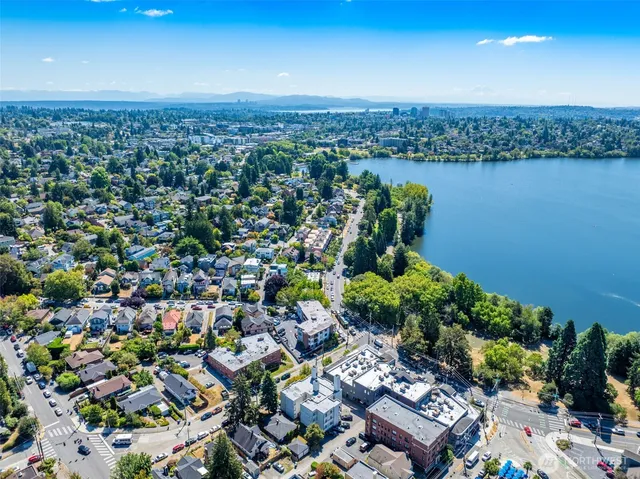 an aerial view of a residential houses with outdoor space and ocean view