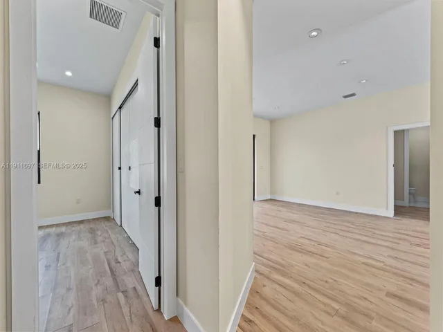 a view of hallway with wooden floor