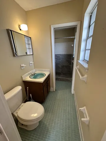 a bathroom with a sink toilet and mirror