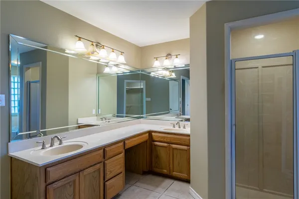 a bathroom with a sink double vanity and a mirror