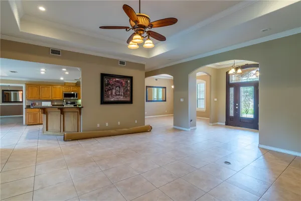 a view of an empty room with a kitchen