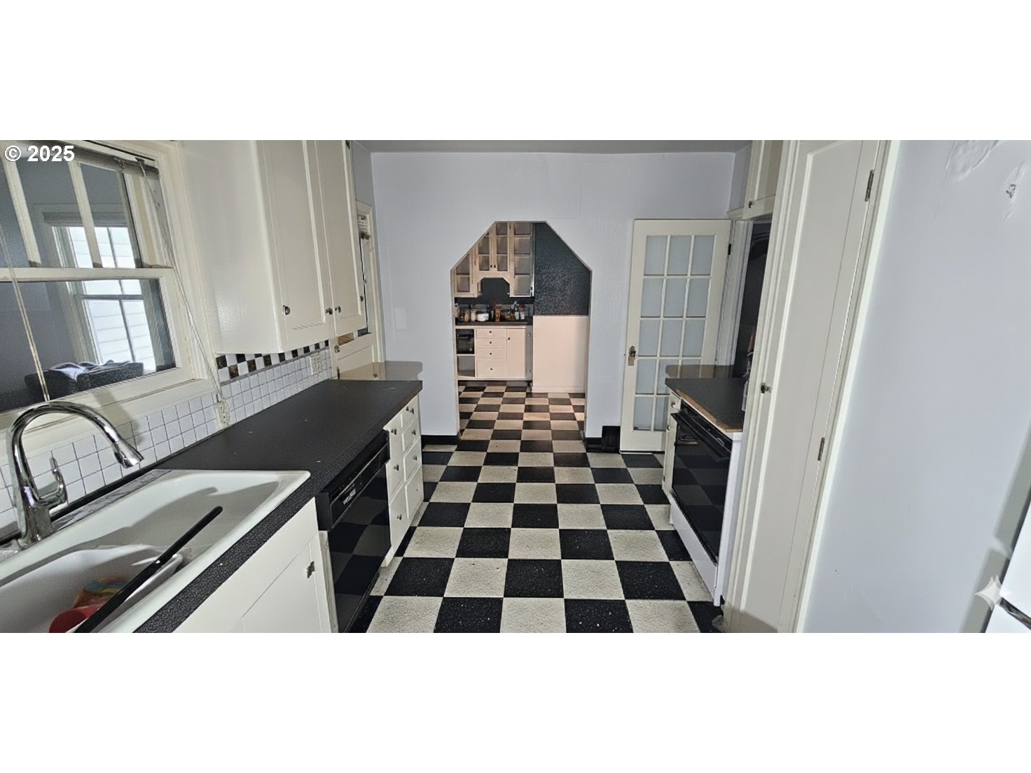 5836 Northeast Halsey Street Portland, OR 97213 - Photo 5 of 12 a kitchen with a sink a refrigerator and cabinets