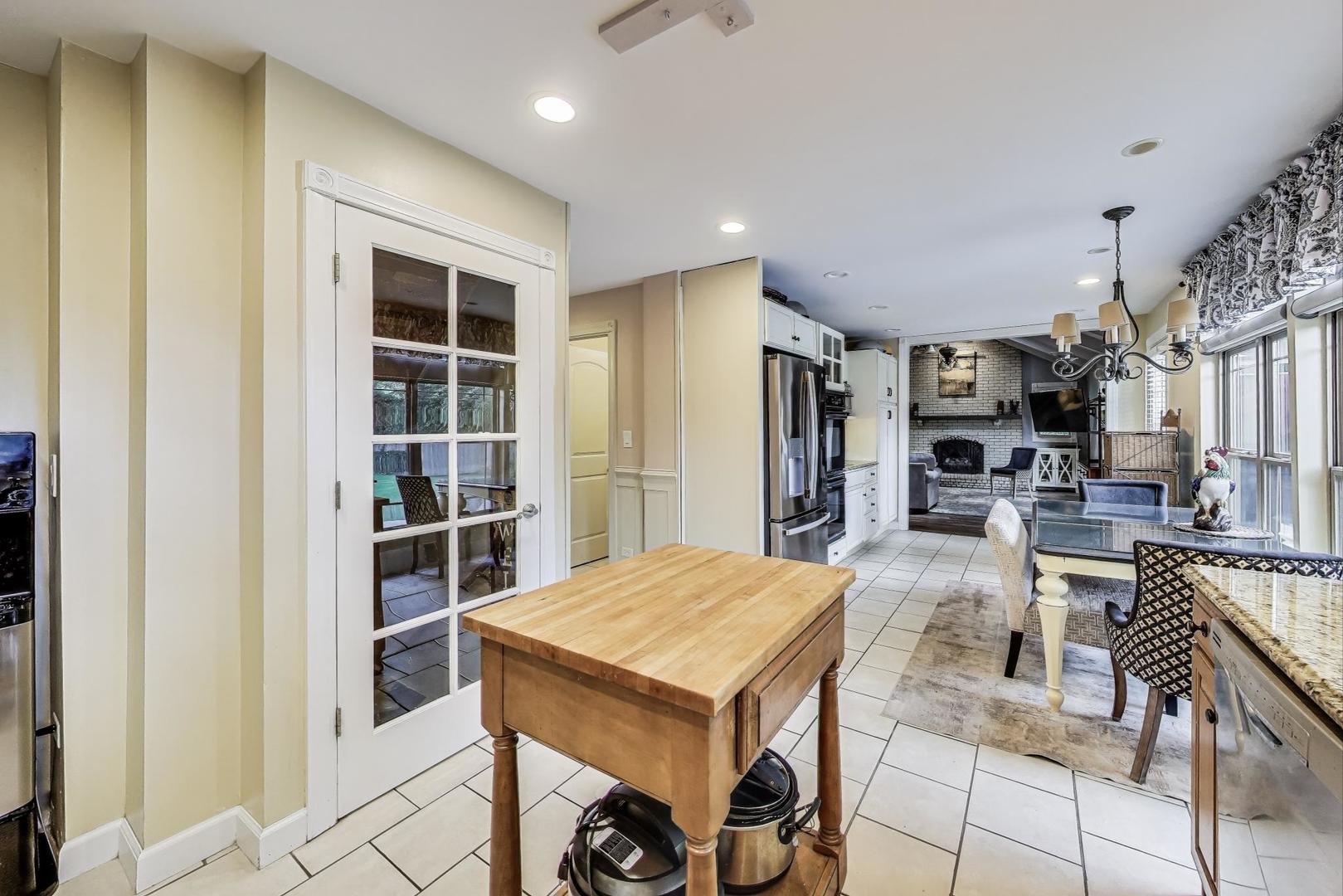 28W409 Leverenz Road Naperville, IL 60564 - Photo 11 of 39 a kitchen with stainless steel appliances kitchen island a table and chairs in it