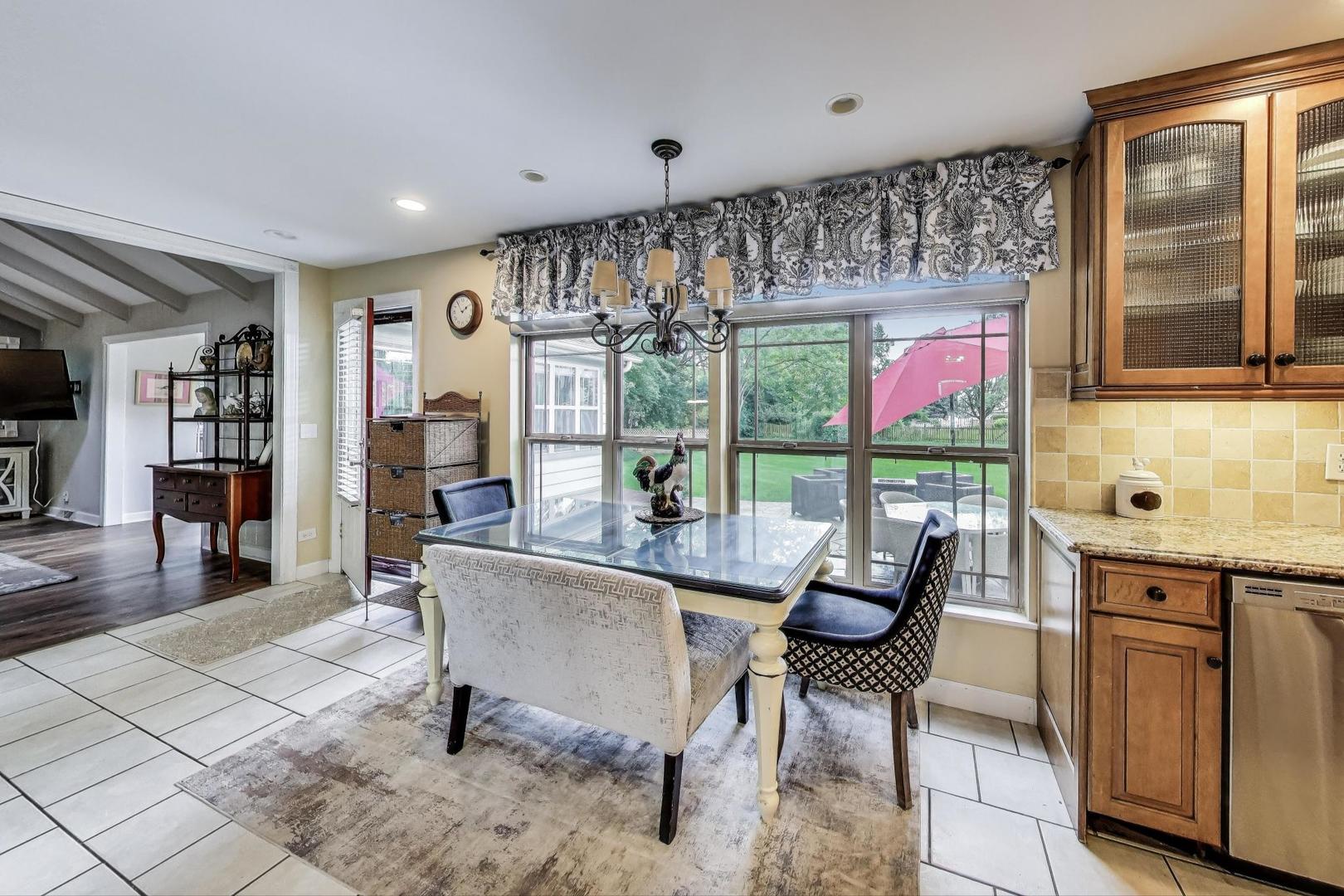28W409 Leverenz Road Naperville, IL 60564 - Photo 12 of 39 a living room with furniture and a floor to ceiling window