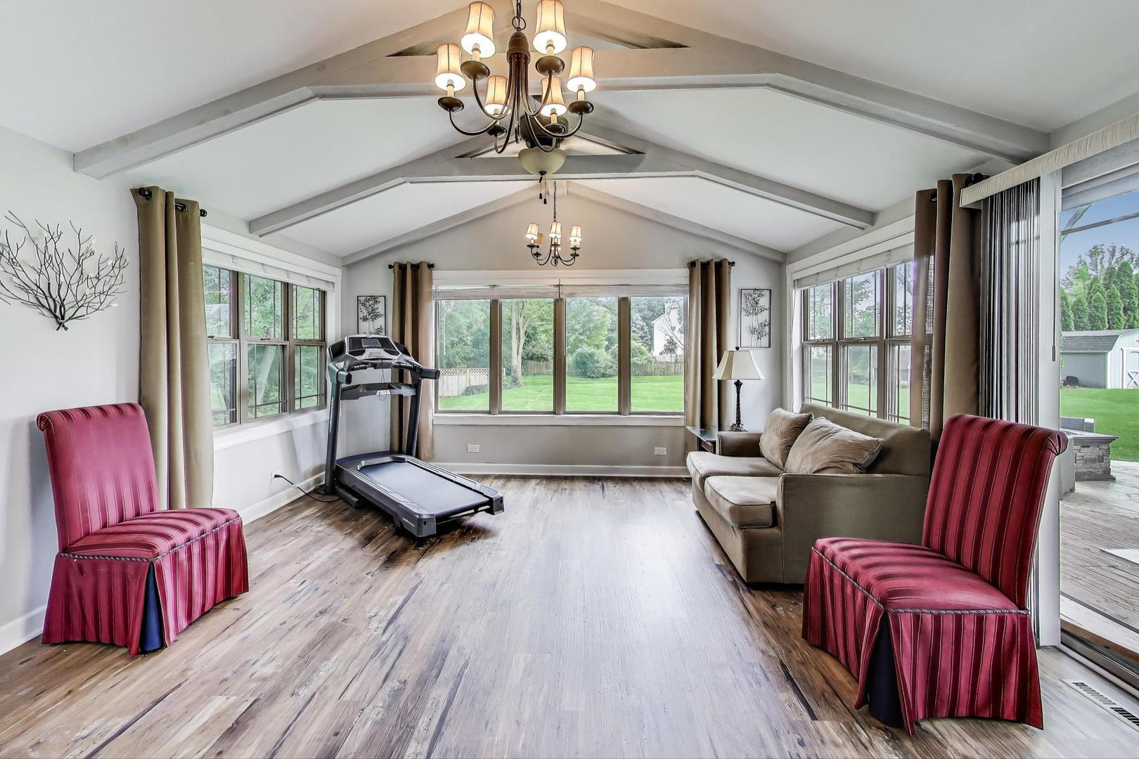 28W409 Leverenz Road Naperville, IL 60564 - Photo 16 of 39 a living room with furniture gym equipment and a large window