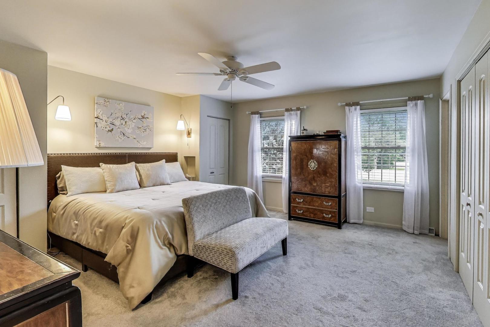 28W409 Leverenz Road Naperville, IL 60564 - Photo 21 of 39 a spacious bedroom with a bed and a walk in closet