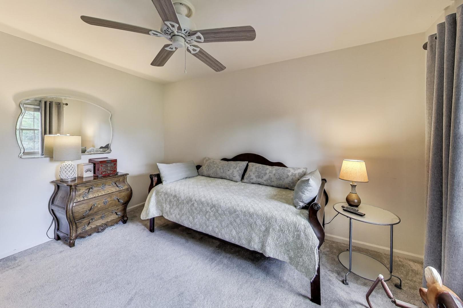 28W409 Leverenz Road Naperville, IL 60564 - Photo 26 of 39 a bedroom with a bed and a lamp