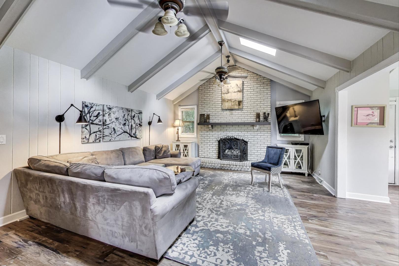 28W409 Leverenz Road Naperville, IL 60564 - Photo 3 of 39 a living room with furniture a flat screen tv and a fireplace