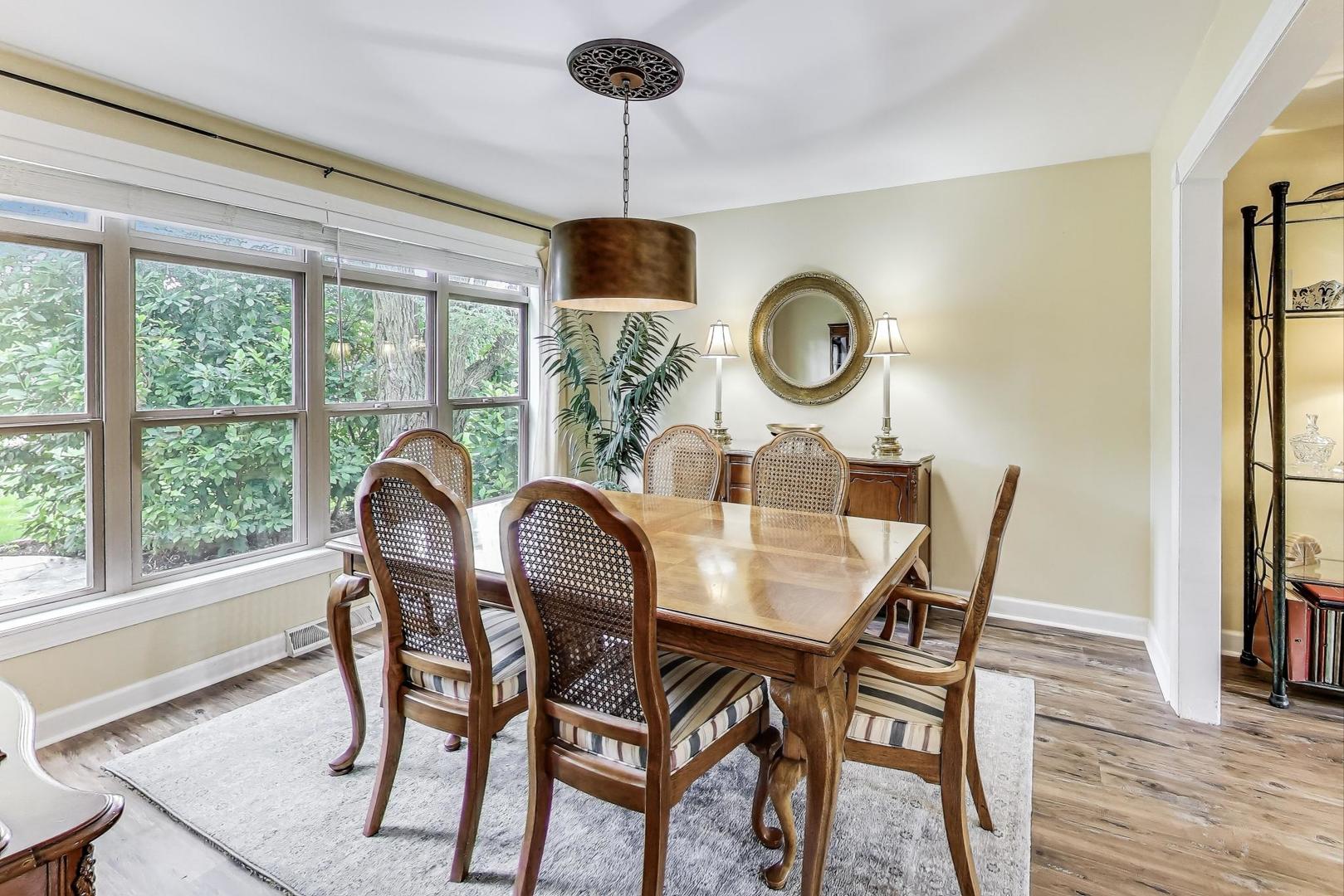 28W409 Leverenz Road Naperville, IL 60564 - Photo 7 of 39 a dining room with furniture a chandelier and wooden floor