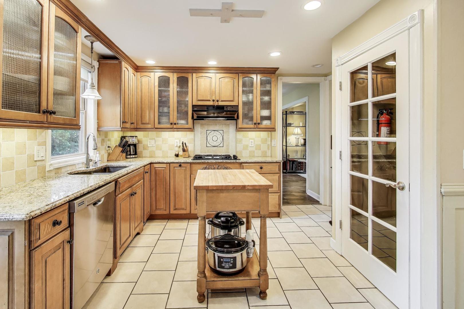 28W409 Leverenz Road Naperville, IL 60564 - Photo 9 of 39 a kitchen with stainless steel appliances granite countertop a sink and cabinets