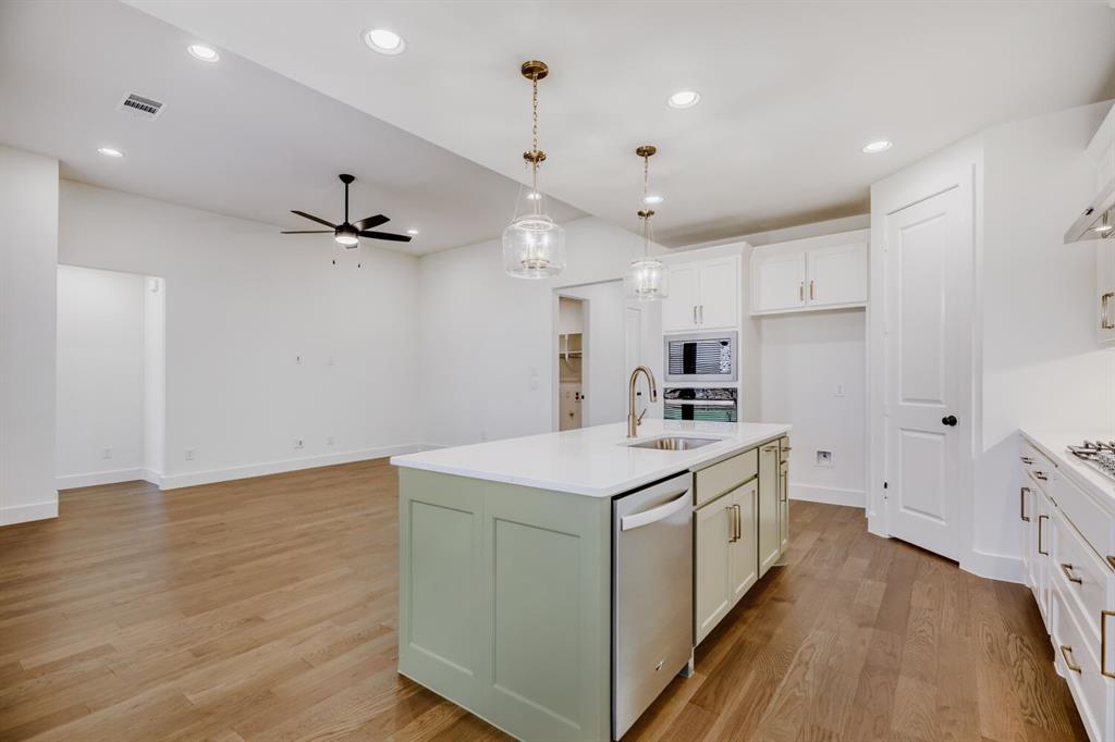 4314 Haley Way Oak Point, TX 75068 - Photo 11 of 28 Contemporary kitchen island with a light green finish and white countertop