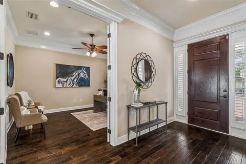 a living room with furniture potted plant and a flat screen tv